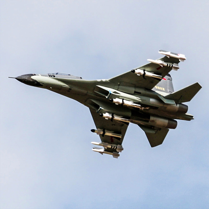 FMS J-11 jet soaring with missiles under wings, showcasing realistic design and details.
