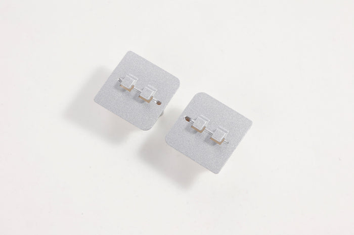 Gray landing gear base connectors for RC models.