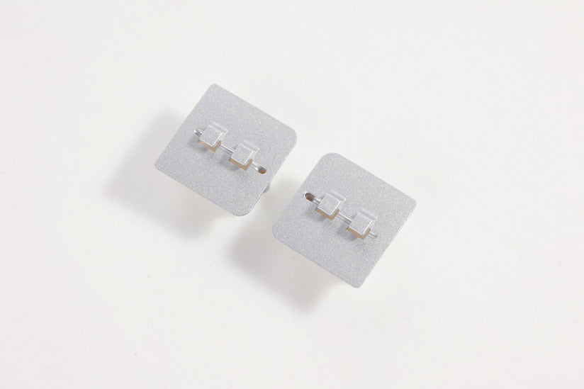 Gray landing gear base connectors for RC models.