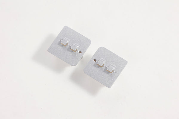 Gray landing gear base connectors for RC models.